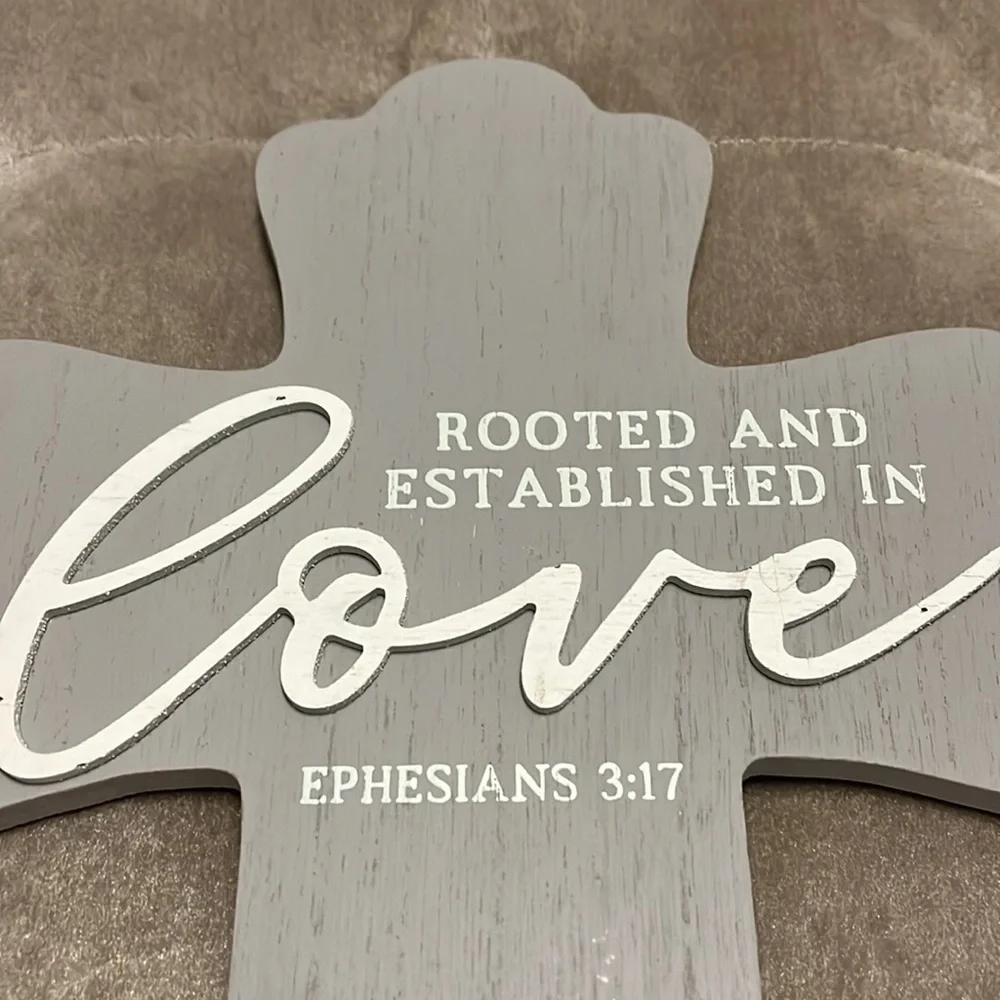 Gray wooden cross with white printing, rooted and established in love, Eph 3:17